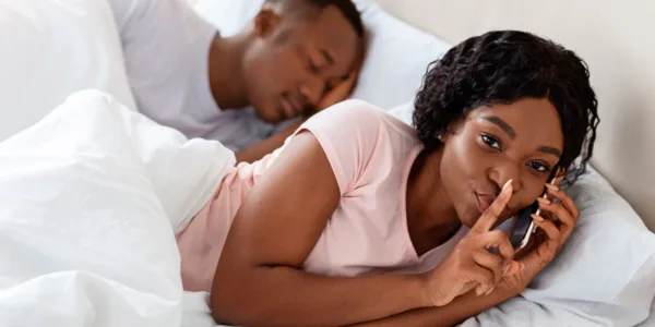 InvestigationHotline-Infidelity-Private-Investigator-Toronto-woman-cheating-her-husband-talking-lover-phone-mobile-bed-sleeping-relationships